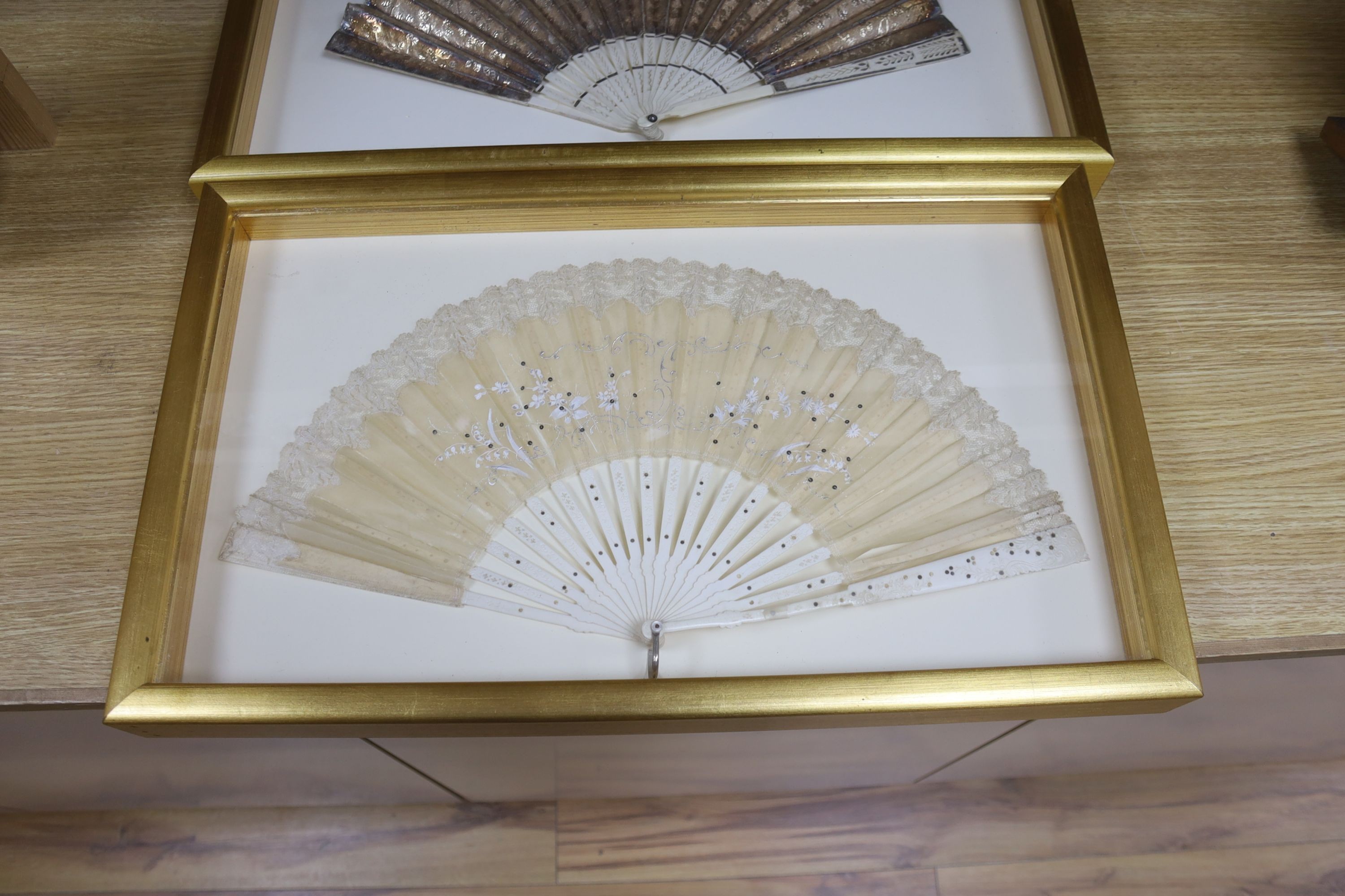 Two 19th century lace edged hand painted fans and a gilt and ivory fan, in 3 cases, largest case 42 x 67 cm